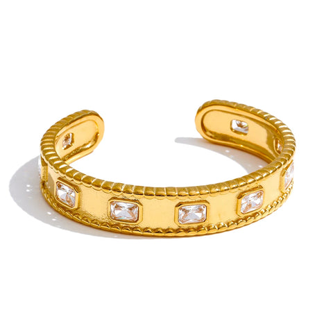 Gold open cuff bracelet with embedded crystals on a white background Gold open cuff bracelet with embedded crystals on a white background