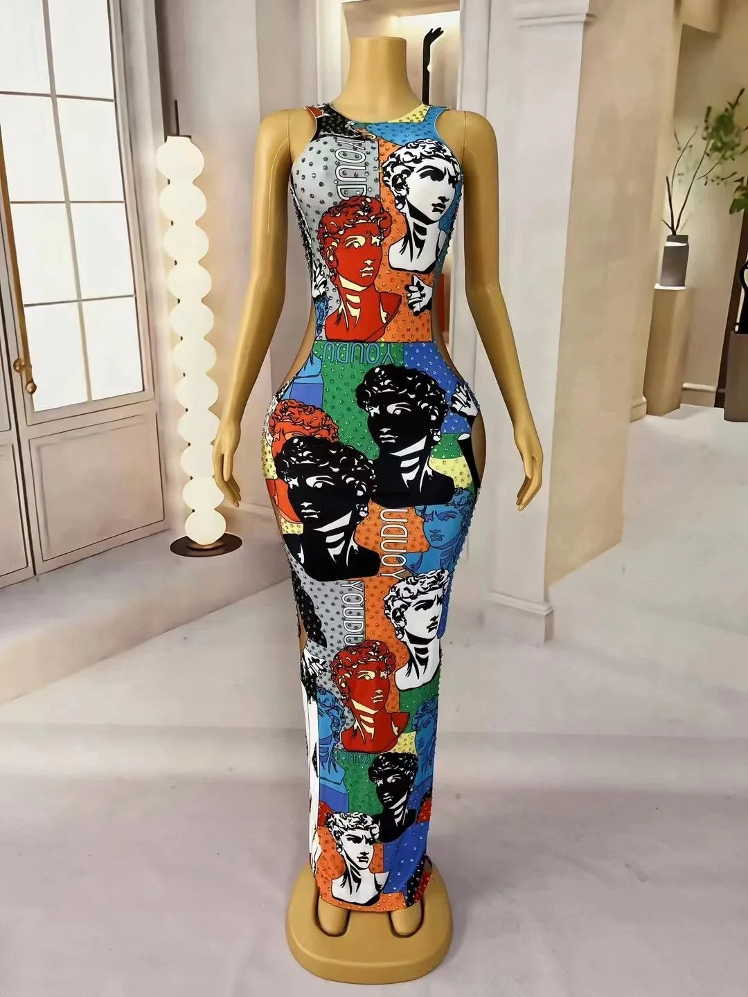 Mannequin wearing a colorful dress with graphic designs in a room. Mannequin wearing a colorful dress with graphic designs in a room.