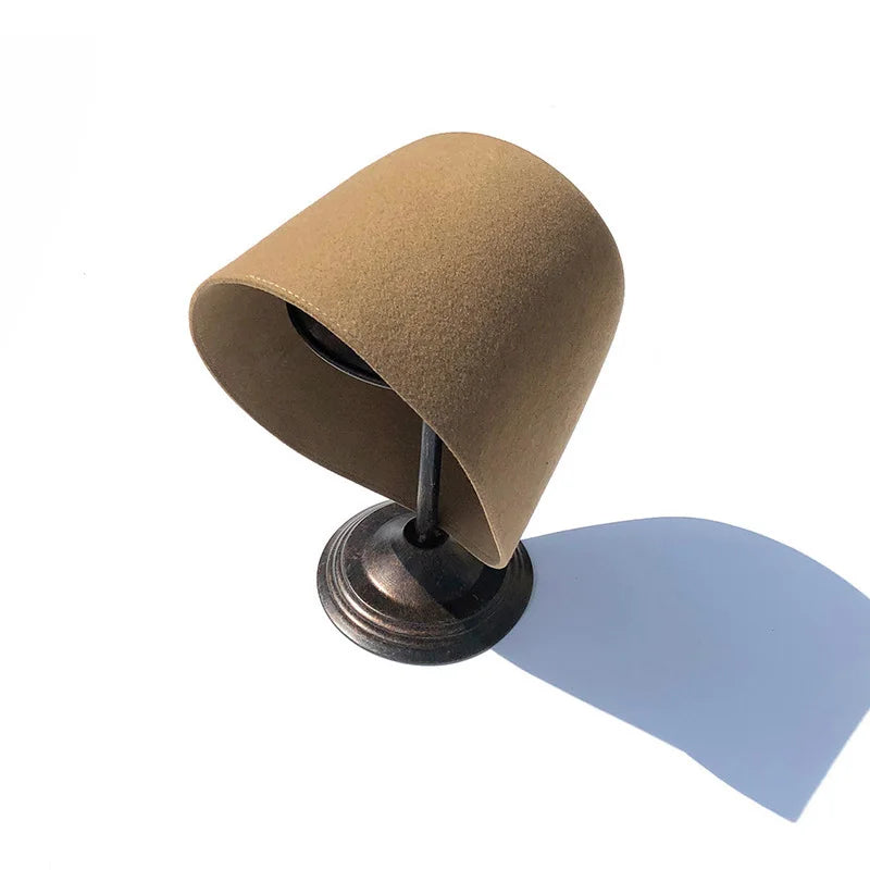 Brown felt hat on a stand with a white background Brown felt hat on a stand with a white background