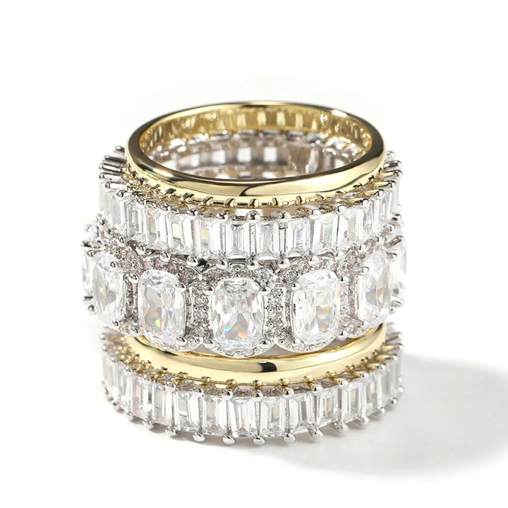 Gold and silver ring with clear gemstones on a white background, branded 'Uwin'.