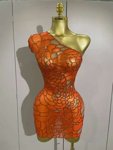 Orange beaded dress on a mannequin against a plain background