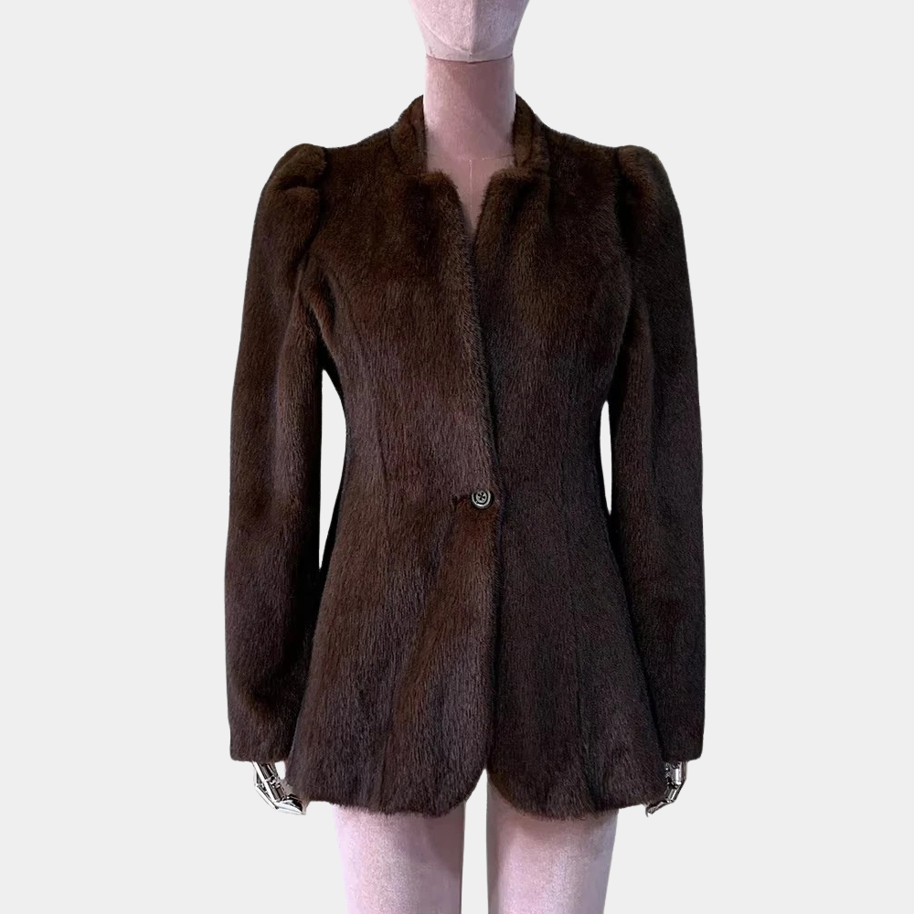 Brown fur coat on a mannequin against a plain background