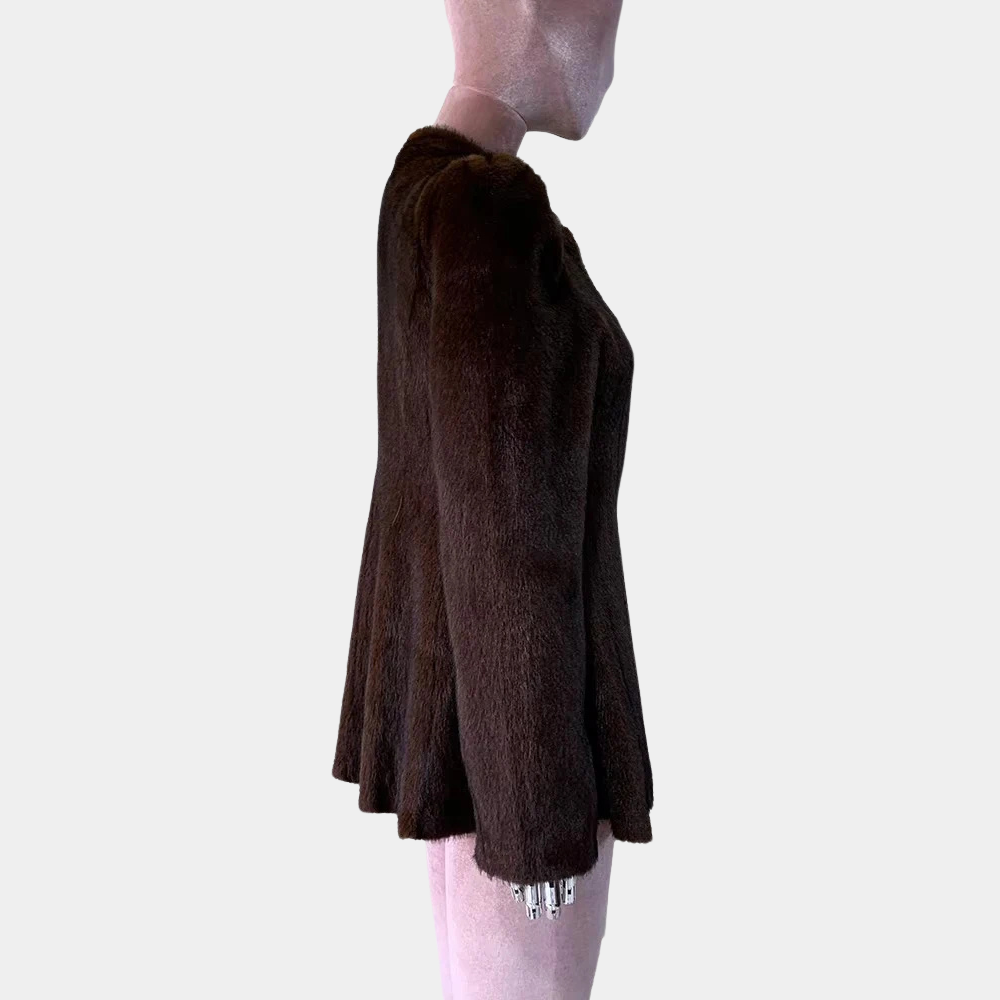 Brown textured skirt worn by a person on a plain background